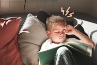 Boy couch reading headache